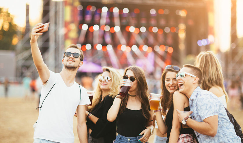 friends drinking beer at concert friends drinking beer at concert